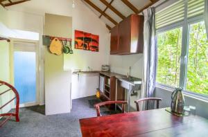 eine Küche mit einem Tisch und Stühlen sowie einem Fenster in der Unterkunft Mangrove Paradise Resort & spa in Galle