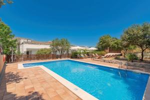a swimming pool in the backyard of a house at Boutique Hotel Oriola in Cala de Sant Vicenc