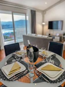 a dining room table with plates and wine glasses at Oskar in Podstrana