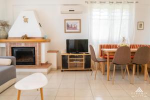 TV a/nebo společenská místnost v ubytování Villa Poseidon