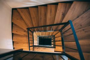 a spiral staircase in a room with wooden walls at Boutique ChaletS Alpi - Private Sauna & Cinema in Garmisch-Partenkirchen