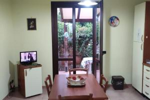 een tafel en stoelen in een keuken met een raam bij Villetta Casa Rosa in Castelluzzo