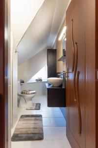 a bathroom with a sink and a toilet at Rosé Apartments in Bogács