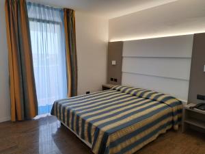 Postel nebo postele na pokoji v ubytování Hotel Consuelo