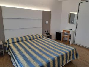 Postel nebo postele na pokoji v ubytování Hotel Consuelo