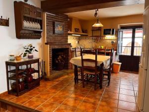 a dining room with a table and a fireplace at Casa Veracruz in Benarrabá