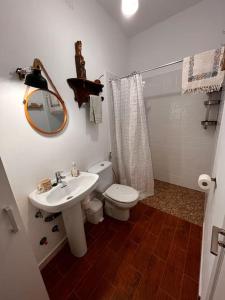 a bathroom with a sink and a toilet and a mirror at Casa Veracruz in Benarrabá +21 photos