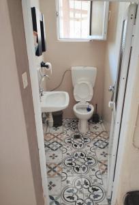 a bathroom with a toilet and a sink at Village house with a nice garden in Stérnai