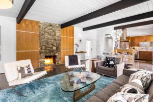 a living room with a couch and a fireplace at Aqua House in Palm Springs
