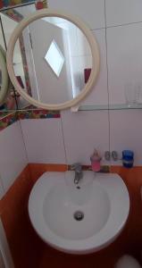 a bathroom with a white sink and a mirror at Filina's Studio in Maltezana +21 photos