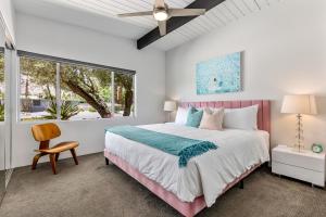 um quarto com uma cama grande e uma janela em Aqua House em Palm Springs