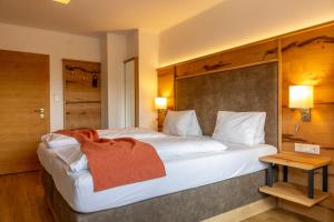 Una cama o camas en una habitación de Hotel-Appartement Hochkönig