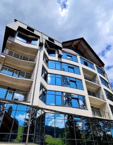 a tall building with glass windows on the side of it at BLUE mountain in Bukovel