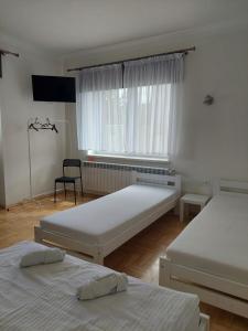 a bedroom with two beds and a window at Noclegi Bachowice - Zator Energylandia Wadowice in Bachowice