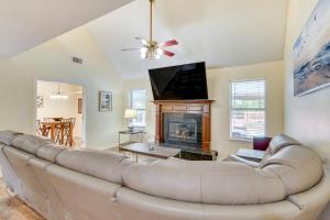 a living room with a couch and a fireplace at Mary Esther Home with Private Pool and Fireplace! in Mary Esther