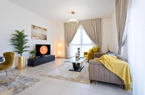 a living room with a couch and a tv at EasyGo - Lamtara 1 Burj Al Arab 2 Bedroom & Maid in Dubai