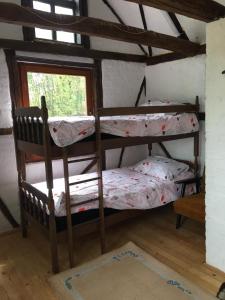 two bunk beds in a room with a window at Etno selo Krugerdorf 