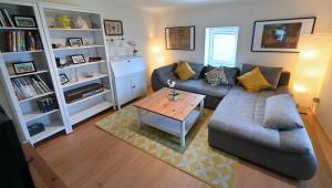 a living room with a couch and a coffee table at Captain's Cabin Piran - free parking in Piran