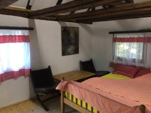 a bedroom with two beds and a table and chairs at Etno selo Krugerdorf 