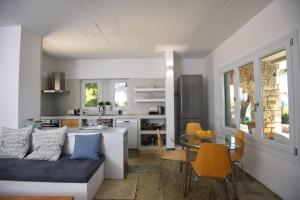 a kitchen and living room with a couch and a table at Kavos Villa in Aghios Petros Alonissos