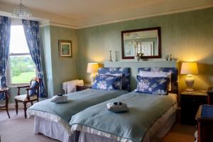 a bedroom with a bed with two towels on it at Ellerton Lodge Bed and Breakfast Swaledale in Richmond