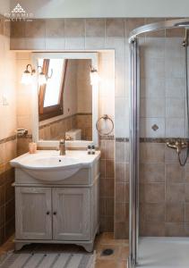 a bathroom with a sink and a shower at Luxury Villa Hera - Beachfront in Roda