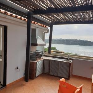 a kitchen with a large view of the water at Atlantico Praia in Praia