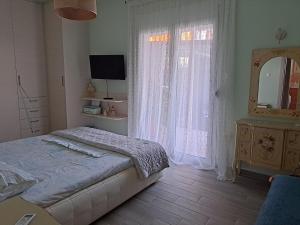 um quarto com uma cama, uma cómoda e um espelho em Elegant house near the sea em Artemida