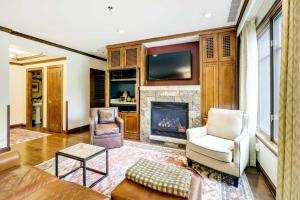 a living room with a fireplace and a tv at Ski Resort Condo in Ritz-Carlton Aspen Highlands in Aspen