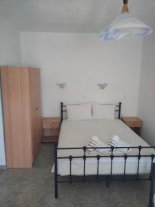 a bedroom with a bed with two pillows on it at Vigla House in Sykia Chalkidikis