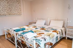 a bedroom with a bed with a tiger quilt at Neptune Sea House - Beachfront in St. Spyridon Corfu