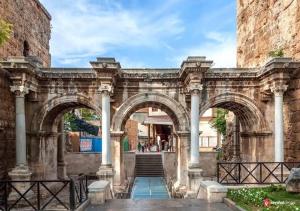 an old stone archway with columns and stairs in a building at Duman homes 2 oda 1 salon in Antalya