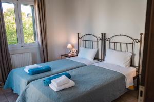 two beds sitting next to each other in a bedroom at Pyramid City Villas in St. Spyridon Corfu