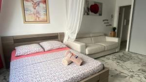 a bedroom with a bed and a couch at AZUR Studio 100 m des plages du Lido in Toulon