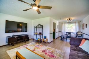 a living room with a couch and a ceiling fan at Palm Bay Vacation Rental with Private Pool! in Palm Bay