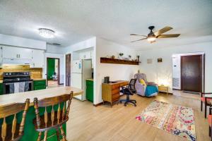 a kitchen and living room with a ceiling fan at Palm Bay Vacation Rental with Private Pool! in Palm Bay