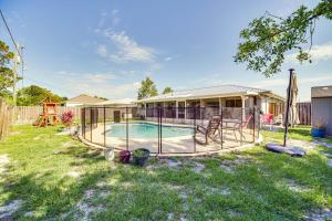 a backyard with a swimming pool and a house at Palm Bay Vacation Rental with Private Pool! in Palm Bay