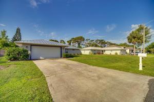 a house with a driveway in a yard at Palm Bay Vacation Rental with Private Pool! in Palm Bay