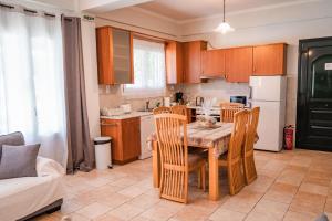 a kitchen with a table and chairs in a room at Pyramid City Villas in St. Spyridon Corfu