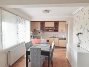 a kitchen and dining room with a table and chairs at Spacious 80m2 Apartment in the Center in Ljubuški
