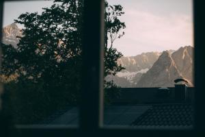 a view of the mountains from a window at Boutique ChaletS Alpi mit Sauna & Kino in Garmisch-Partenkirchen