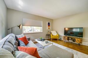 a living room with a couch and a tv at Wyandotte Vacation Rental Apartment Near Hospital! 