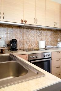 a kitchen with a sink and a stove at Maria’s Sunset House in Megalochori