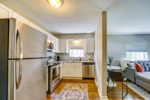 a kitchen and living room with a refrigerator and a couch at Wyandotte Vacation Rental Apartment Near Hospital! 