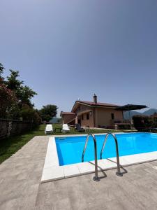 a swimming pool in front of a house at Villa Amalia in Avellino