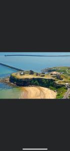an aerial view of an island in the ocean at Village view apartments in Tynemouth