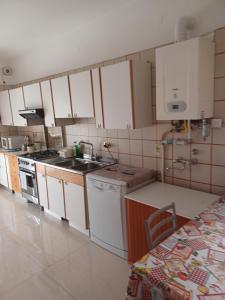 a kitchen with white cabinets and a sink and a stove at Viale Unità D'Italia in Formia