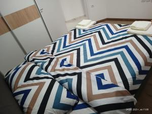 a bed in a room with at Grand Apartments Strumica in Strumica