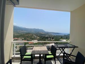 a balcony with tables and chairs and a view at Foto Studios in Himare