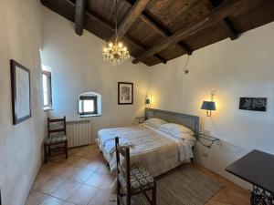 a bedroom with a bed and a table and chairs at La Taberna di Rocca Calascio in Calascio